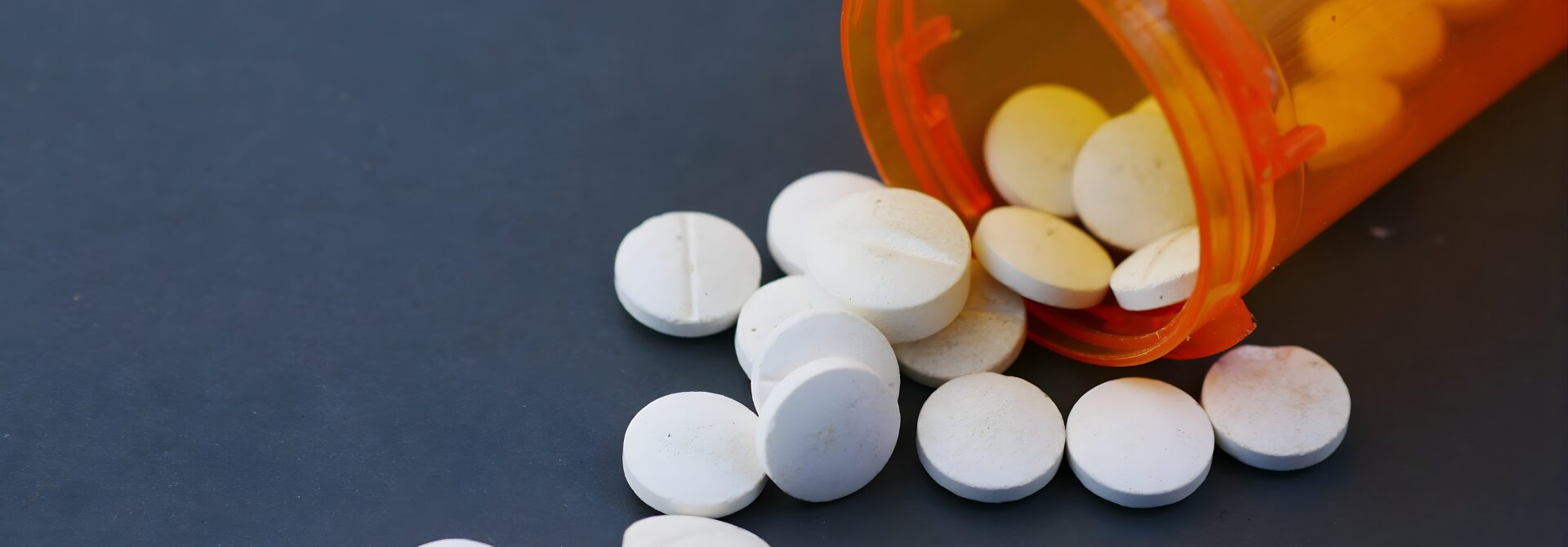 tablets spilling out of of a pill bottle