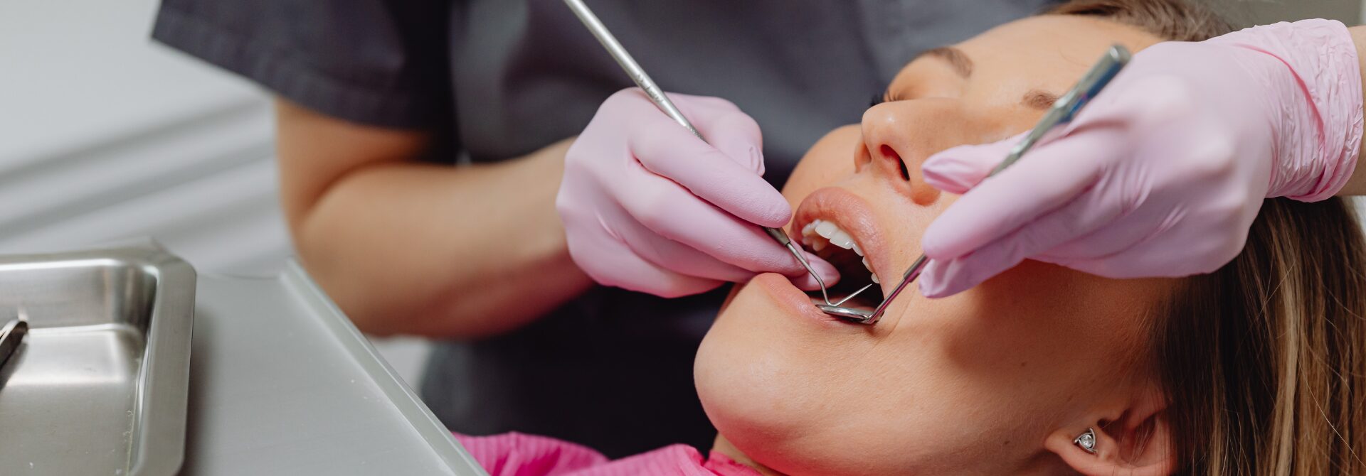Dentist looking in a female patients mouth