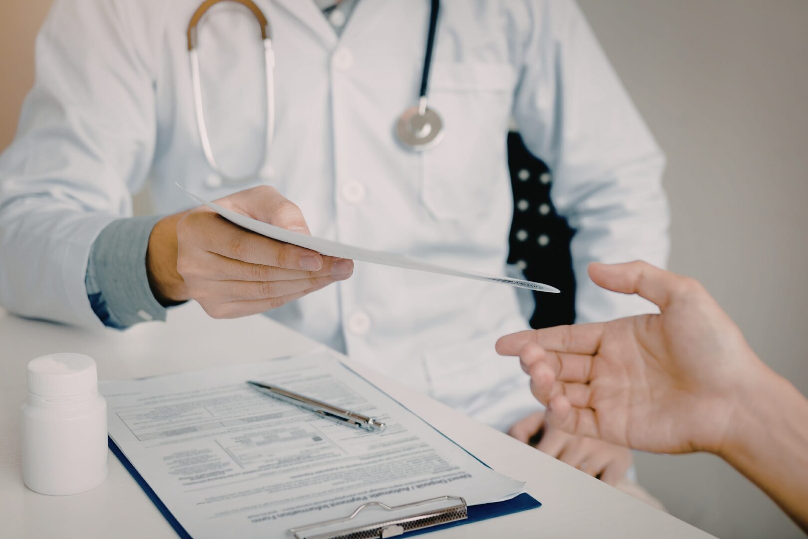 doctor handing a patient some paperwork
